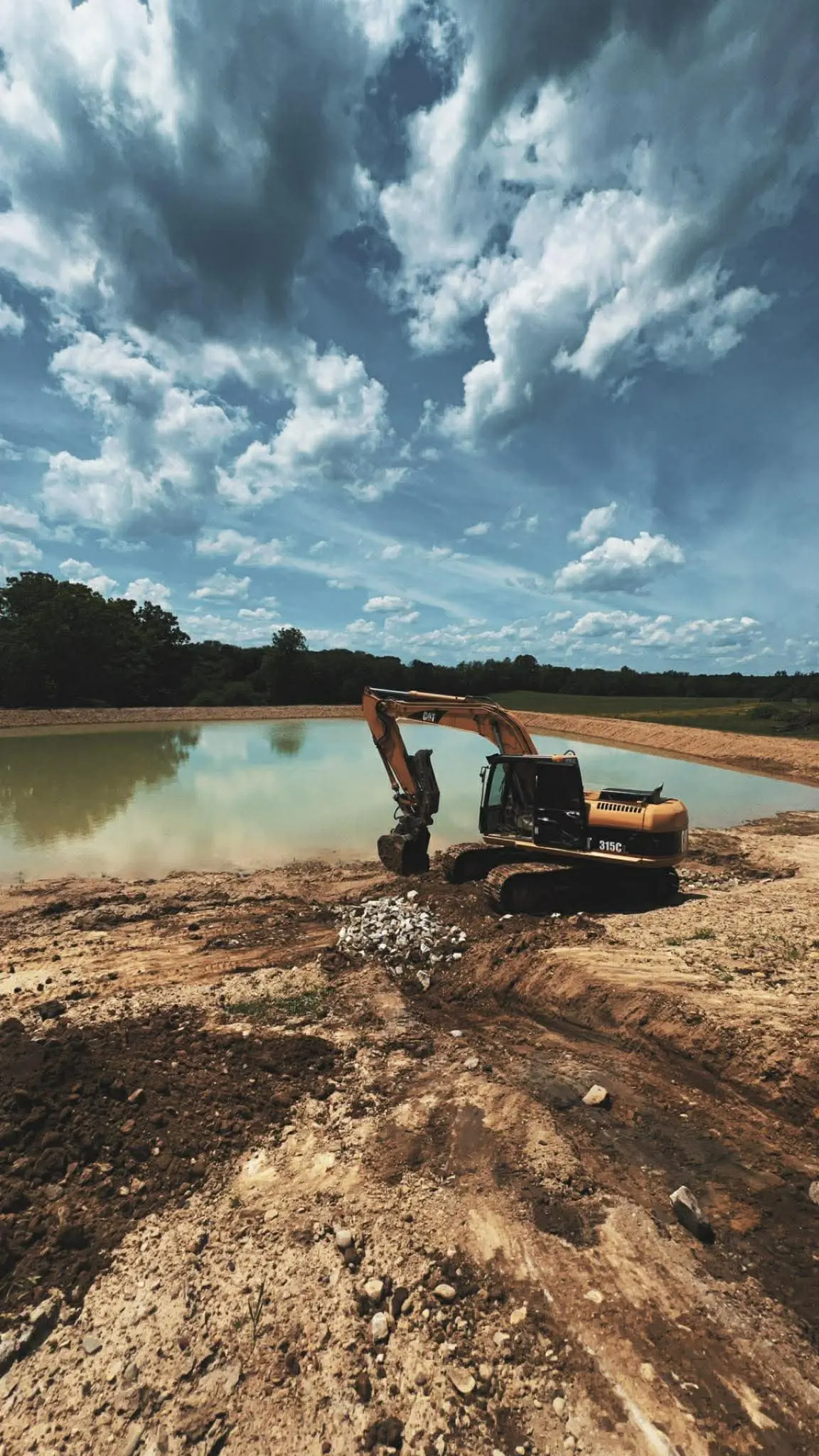 Caterpillar 315 excavator at a Western PA pond build site by Poole Dirt Work