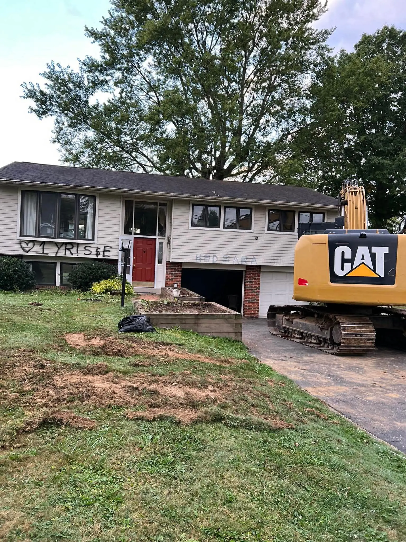 CAT excavator preparing a residential structure for demolition by Poole Dirt Work