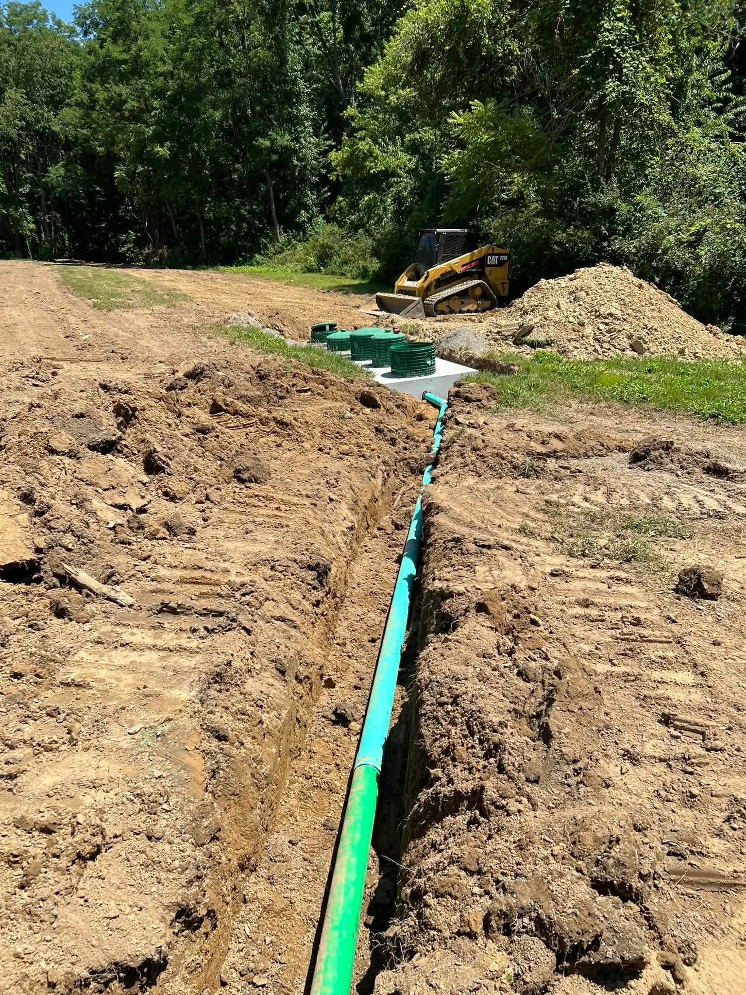 Septic line trench dug down a long driveway approach in Mercer County